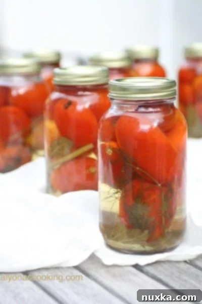 A jar of finished Ukrainian Pickled Tomatoes, ready to be stored