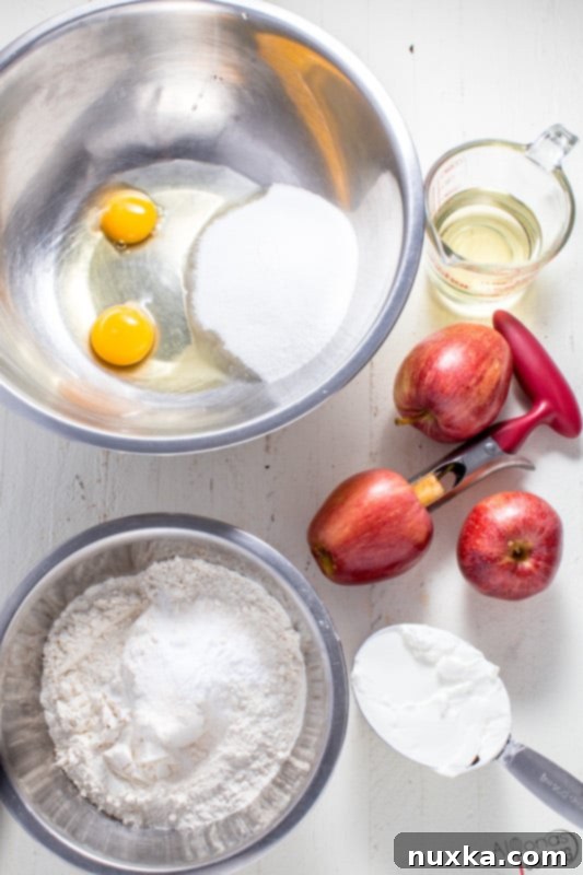 Bowl of chopped apples and other ingredients for apple cinnamon cake on a kitchen counter