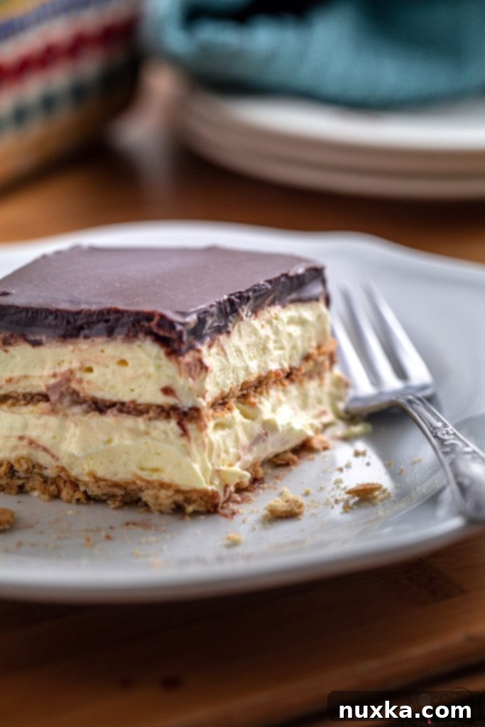 Delicious No-Bake Chocolate Eclair Cake layered with vanilla pudding and graham crackers