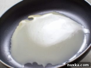 Step 4: Flipping a crepe in the skillet.