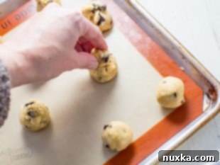 Scooping and rolling cookie dough into balls