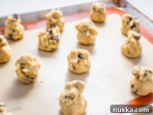Arranging cookie dough balls on a baking sheet
