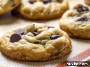 Baked chocolate chip cookies cooling on a rack