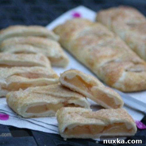 Golden brown braided apple hand pies cooling on a rack, ready to eat