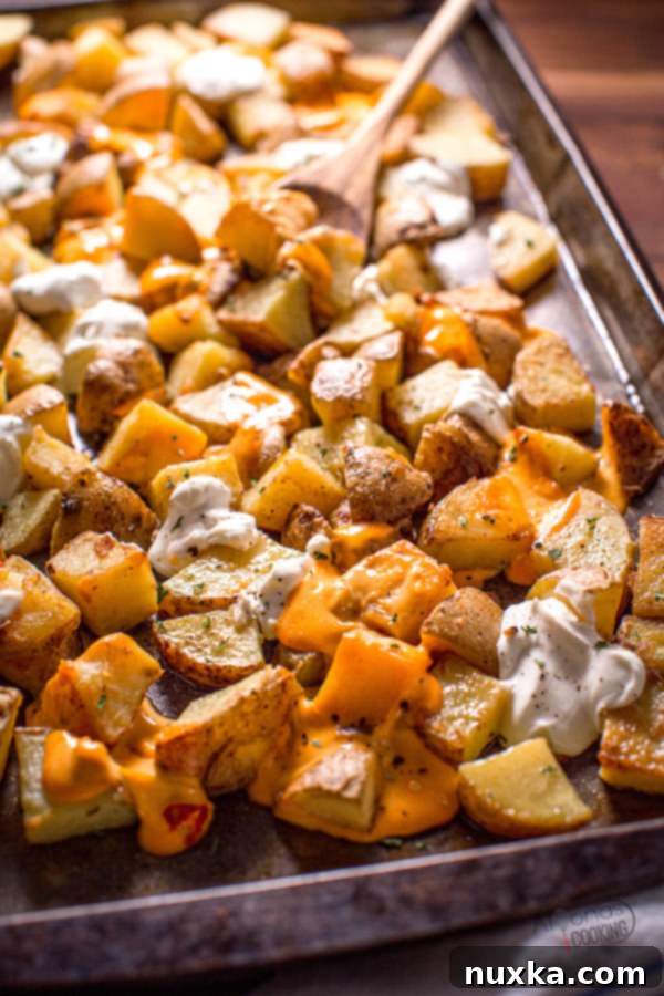 Close-up of the delicious loaded baked potato casserole, showcasing melted cheese and creamy toppings.