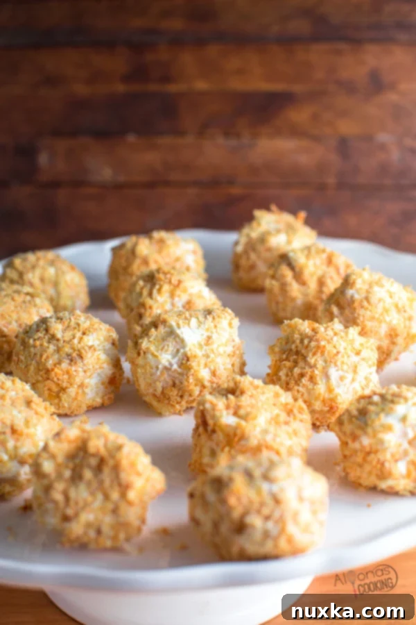 Napoleon Cake Balls arranged neatly on a serving platter, showcasing their golden puff pastry and creamy coating.
