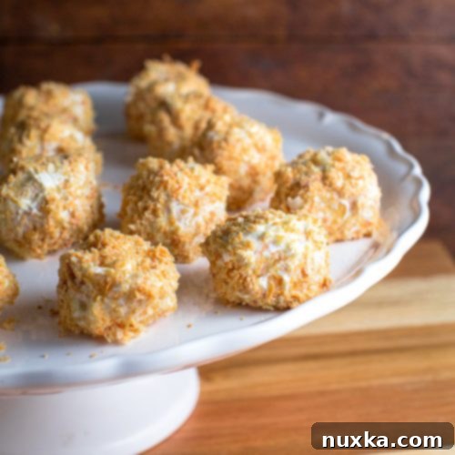 Finished Napoleon Cake Balls, perfectly coated in cream and crumbs.