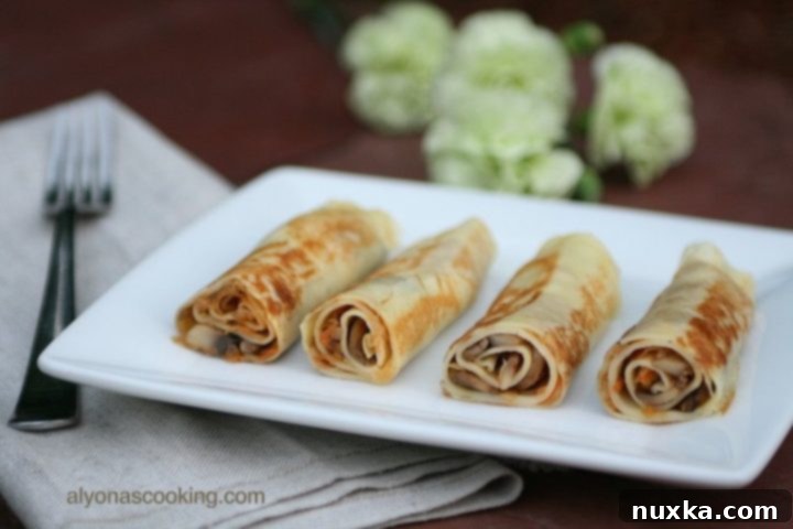 Delicious Cabbage and Mushroom Savory Crepes ready to serve, a traditional Ukrainian blini recipe.