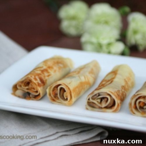 Cabbage and Mushroom Savory Crepes stacked on a plate