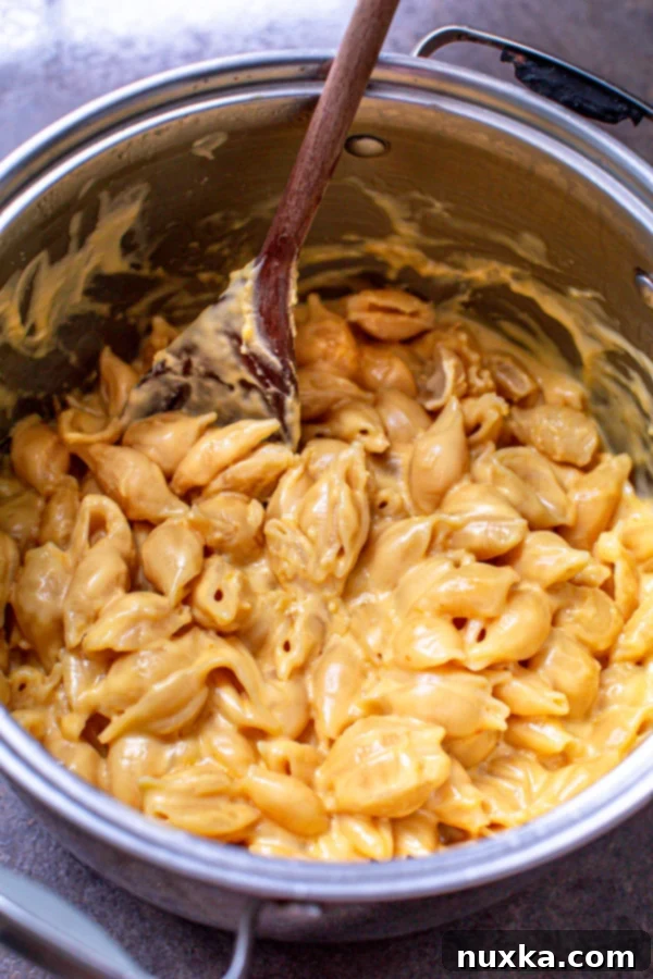 Deliciously creamy macaroni and cheese cooking on the stovetop in a single pot
