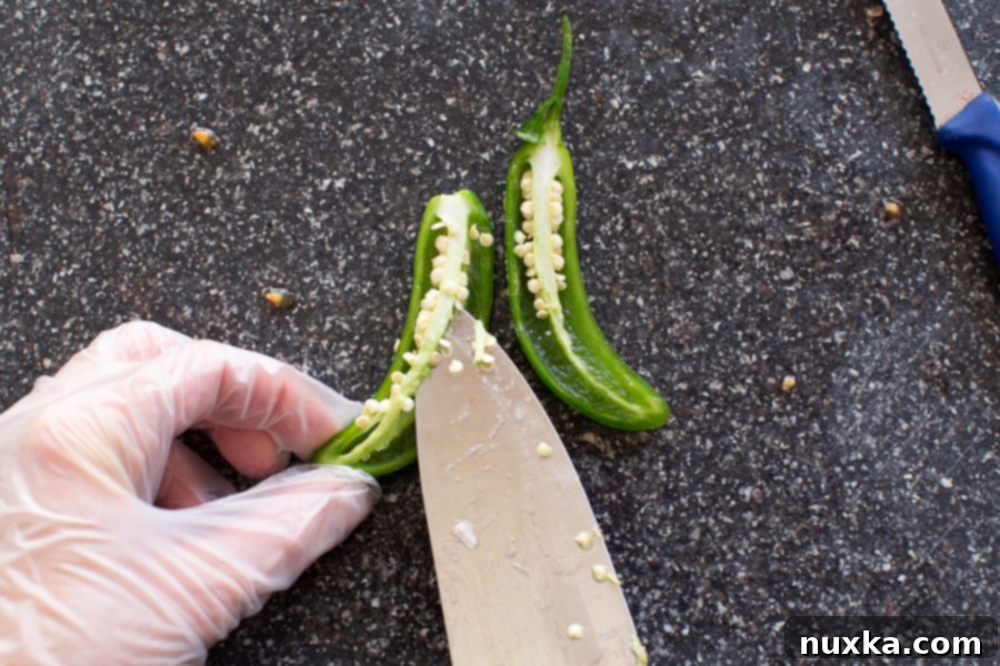 Expert tips for safely cutting and preparing jalapeño peppers for pico de gallo, including removing seeds and veins.