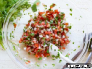 Finished pico de gallo, freshly mixed and ready to be served or chilled.