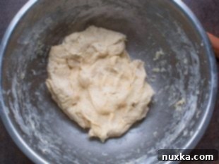 Combining dry ingredients with margarine and warm water for crescent dough