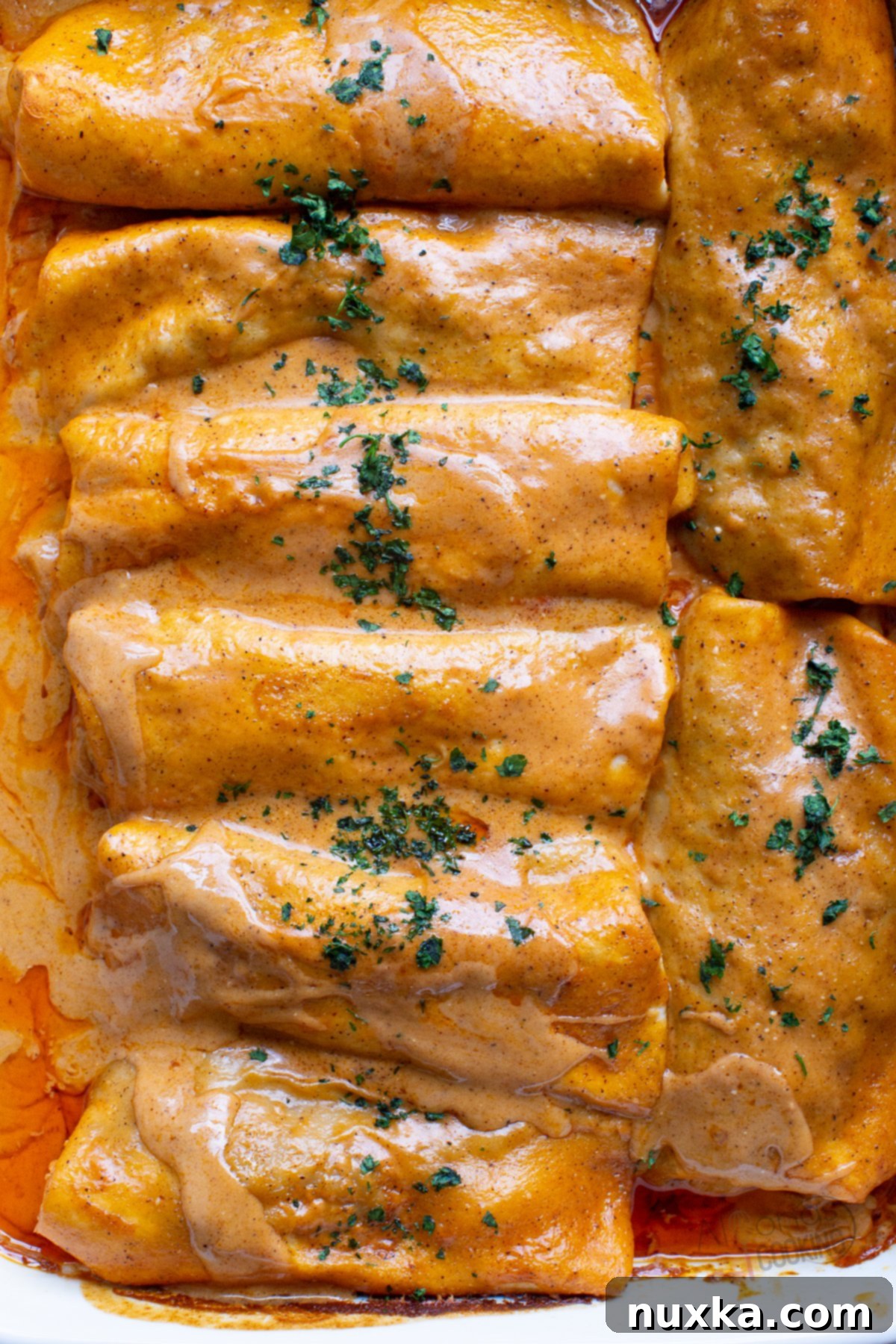 Delicious beef enchiladas covered in homemade red enchilada sauce and cheese, ready to be served.
