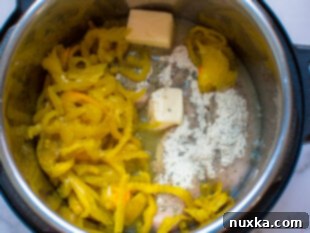 Adding ingredients to the Instant Pot for Mississippi Chicken