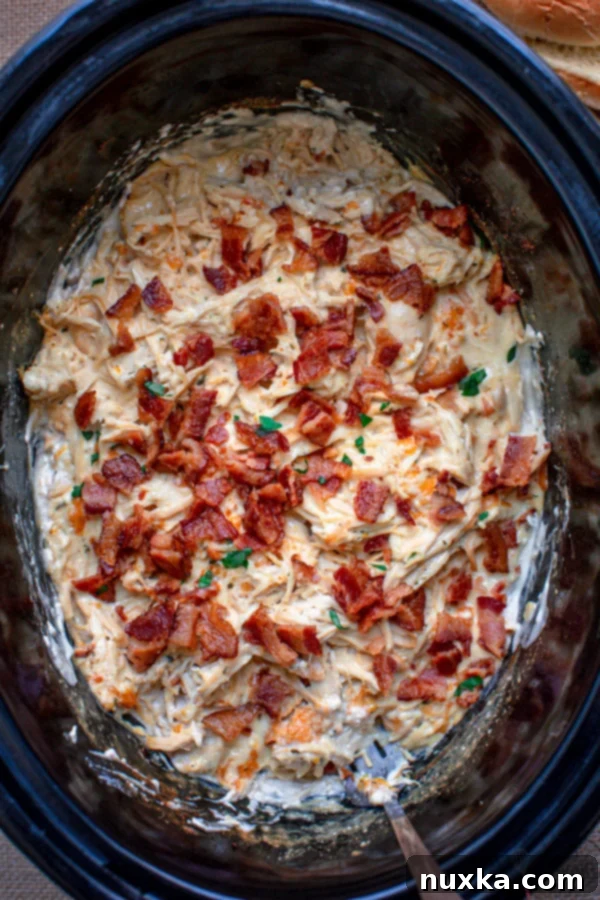 Creamy Slow Cooker Chicken Bacon Ranch Sandwiches with melted cheese, perfect for serving