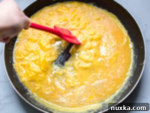 Whisking eggs with milk, salt, and pepper