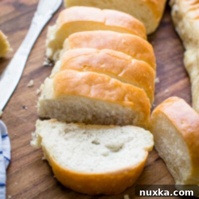 Easy Homemade French Bread 3 Homemade French bread baguette with butter on a wooden cutting board