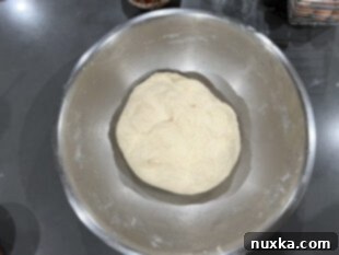 Mixing French bread ingredients into a soft dough