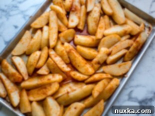Step 3: Potato wedges arranged in a single layer on a baking sheet