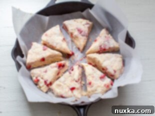 sliced scone wedges in a cast iron pan with parchment paper