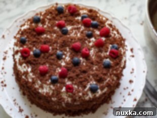 german chocolate cake mix garnished with leftover crumbs and a cream cheese frosting with cool whip