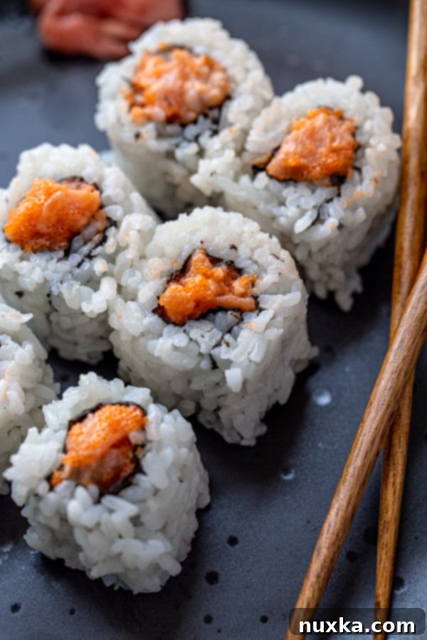 Japanese spicy tuna roll (negitoro) on plate with chopsticks