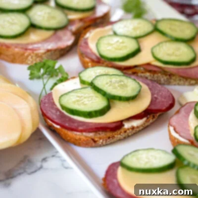 Classic Russian Tea Bites 4 Russian tea sandwiches with kielbasa, cheese and cucumbers on Lithuanian bread