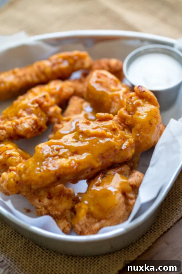 Copycat Boneless Chicken Wings with Golden BBQ sauce and ranch dressing, looking crispy and delicious on a platter.