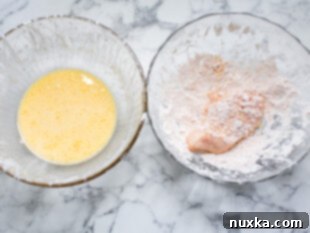 Dredging chicken strips in breading and wet batter