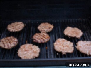 how to grill burgers for juicy results, showing patties on the grill