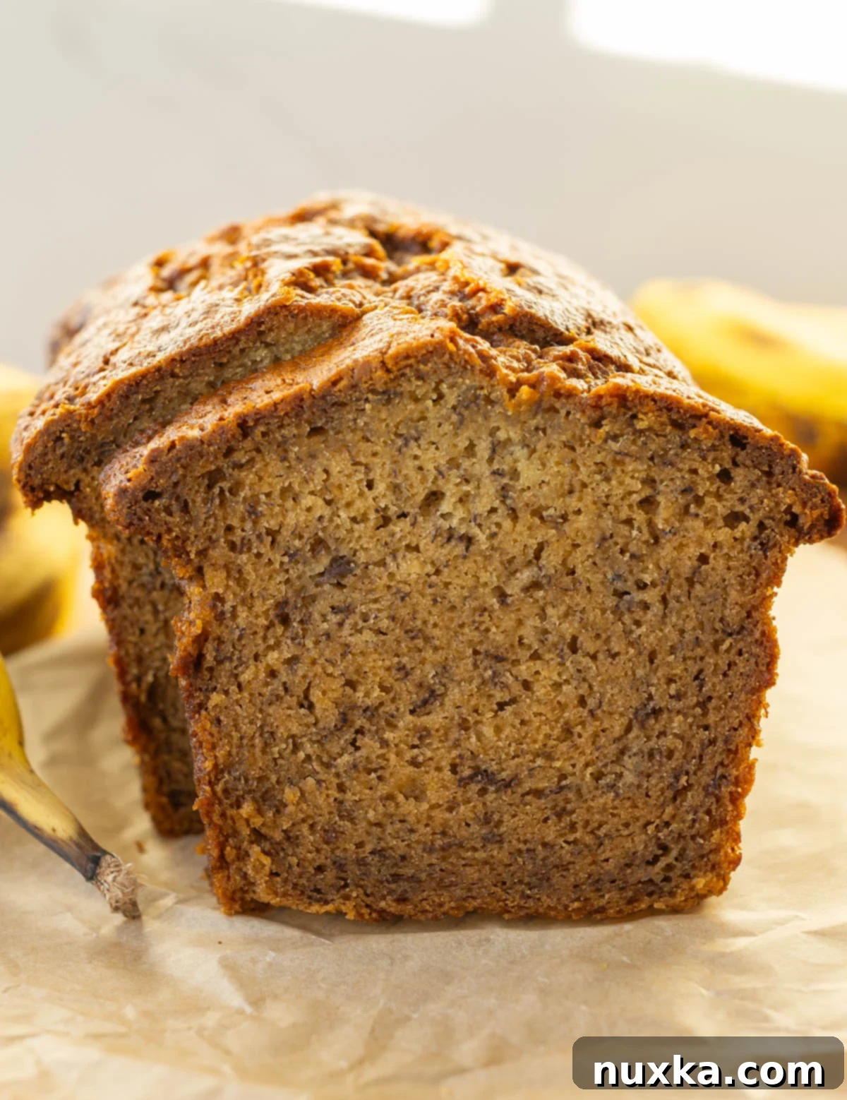 Super moist banana bread loaf with ripe bananas, sliced and ready to serve