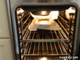banana bread placed in the center rack of an oven to bake