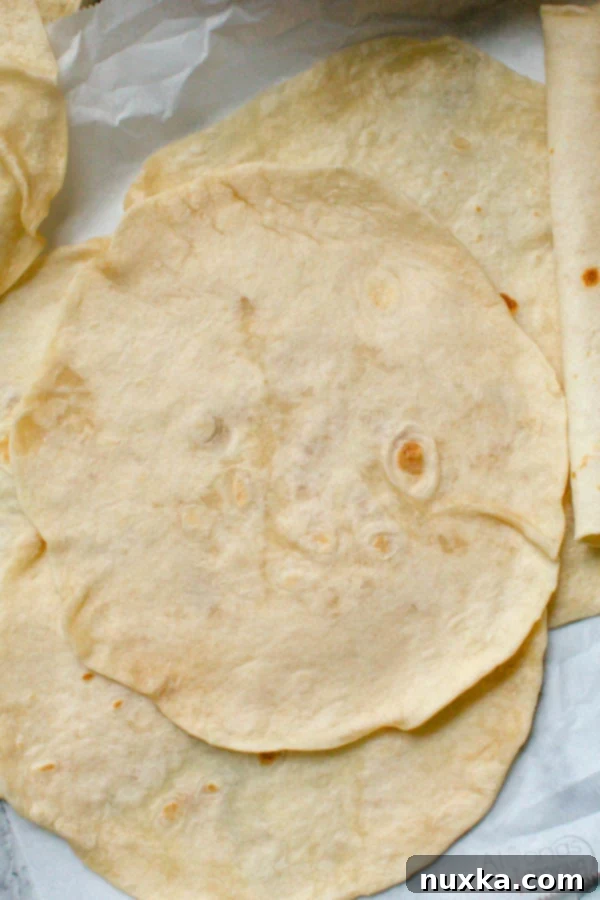 homemade flour tortillas rolled and cooked, perfectly soft and flexible