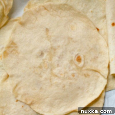Velvety Soft Flour Tortillas 3 homemade flour tortillas rolled and cooked