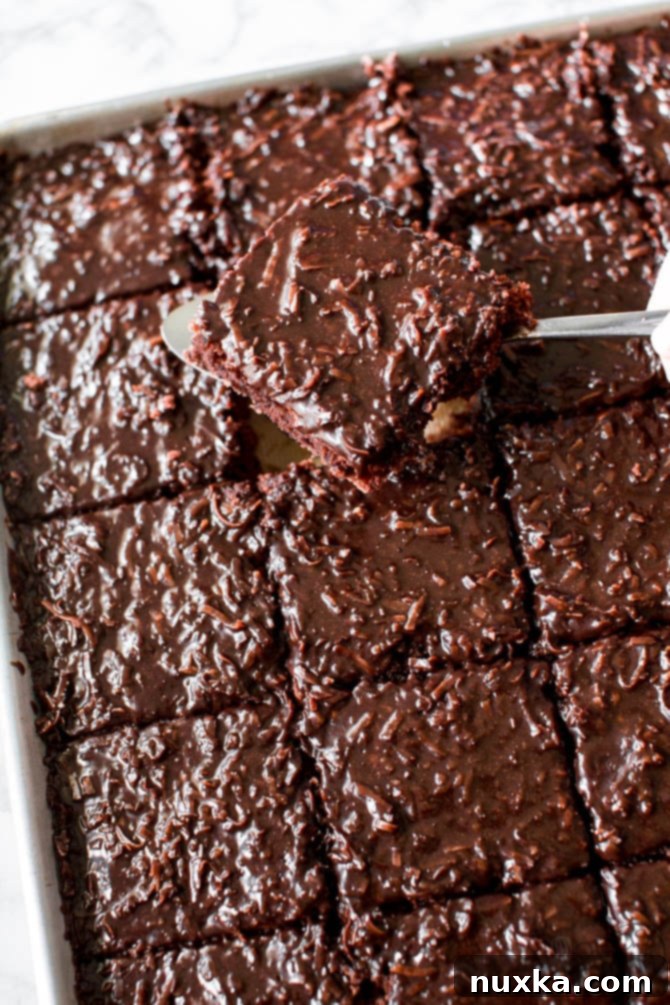 tender chocolate sheet cake slice with a coconut fudge frosting
