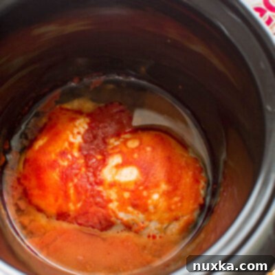 Slow cooker buffalo chicken that can be used for salads, sandwiches, dips, and more.