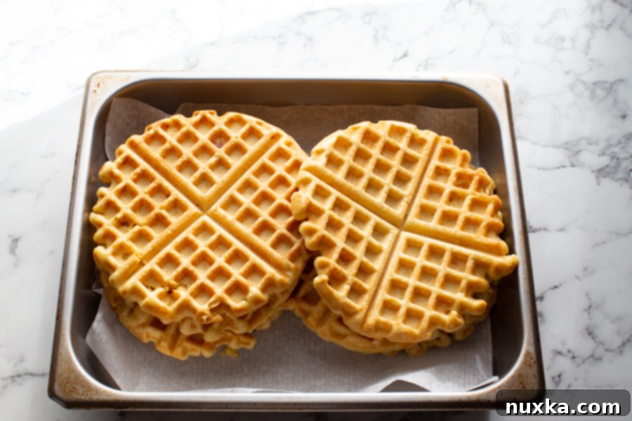 Close-up of frozen pumpkin waffles, stacked and ready for storage, showcasing their convenience for meal prep.