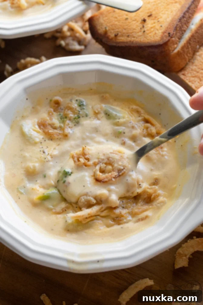 broccoli cheese soup in a soup bowl with spoon