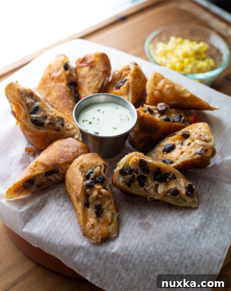 southwest egg rolls deep fried and filled with black beans, Mexican cheese, chicken, cheese, and salsa