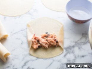 Southwestern egg roll ingredients in a flour tortilla
