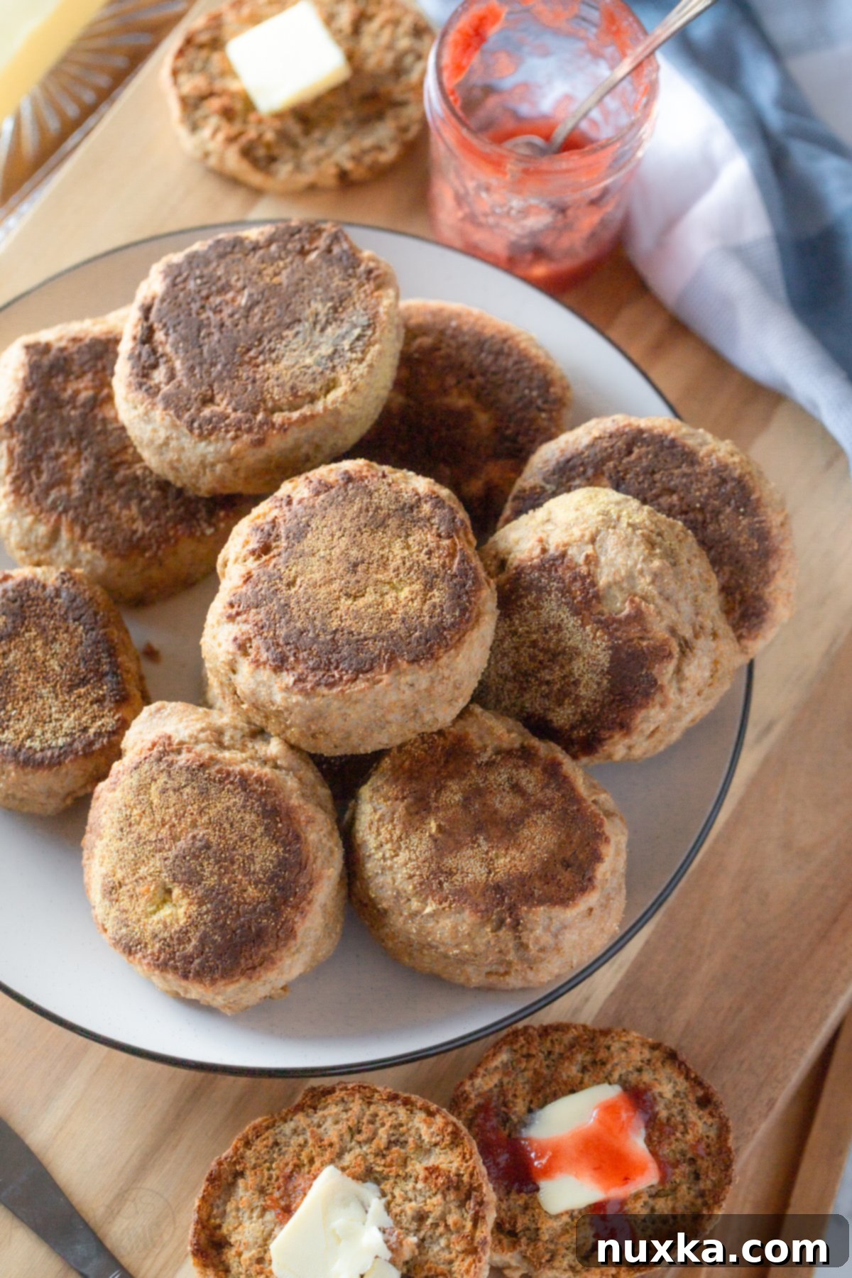 Fluffy sourdough English muffins made with 100% freshly ground whole wheat flour, a healthy and delicious breakfast bread.