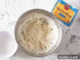 image: how to make crab rangoon filling with cream cheese, powdered sugar, and imitation crab meat. Step:1