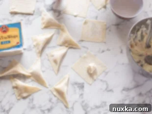 image: how to seal triangle shaped crab rangoon wontons