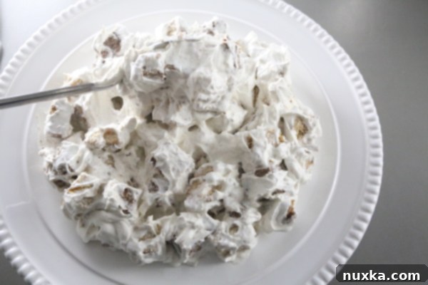 Assembling the Russian Tea Cake (Curly Boy Cake) with cake cubes and cream