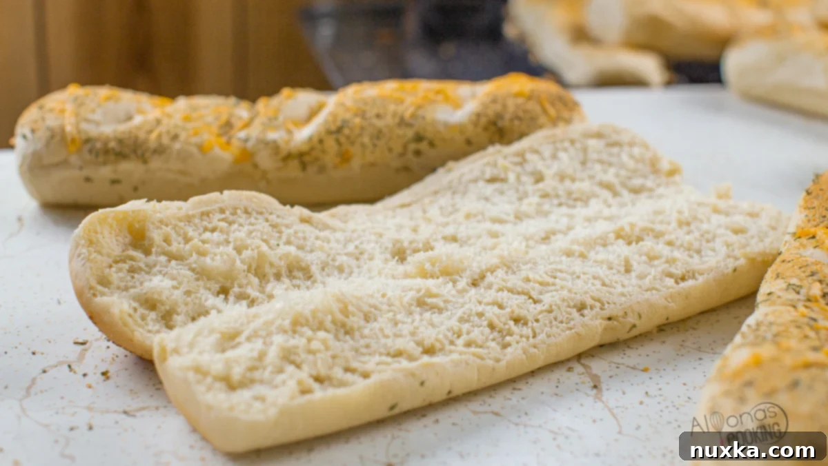 A close-up of the fluffy, airy interior of a freshly baked homemade Subway bread roll, revealing its perfect texture and crumb.