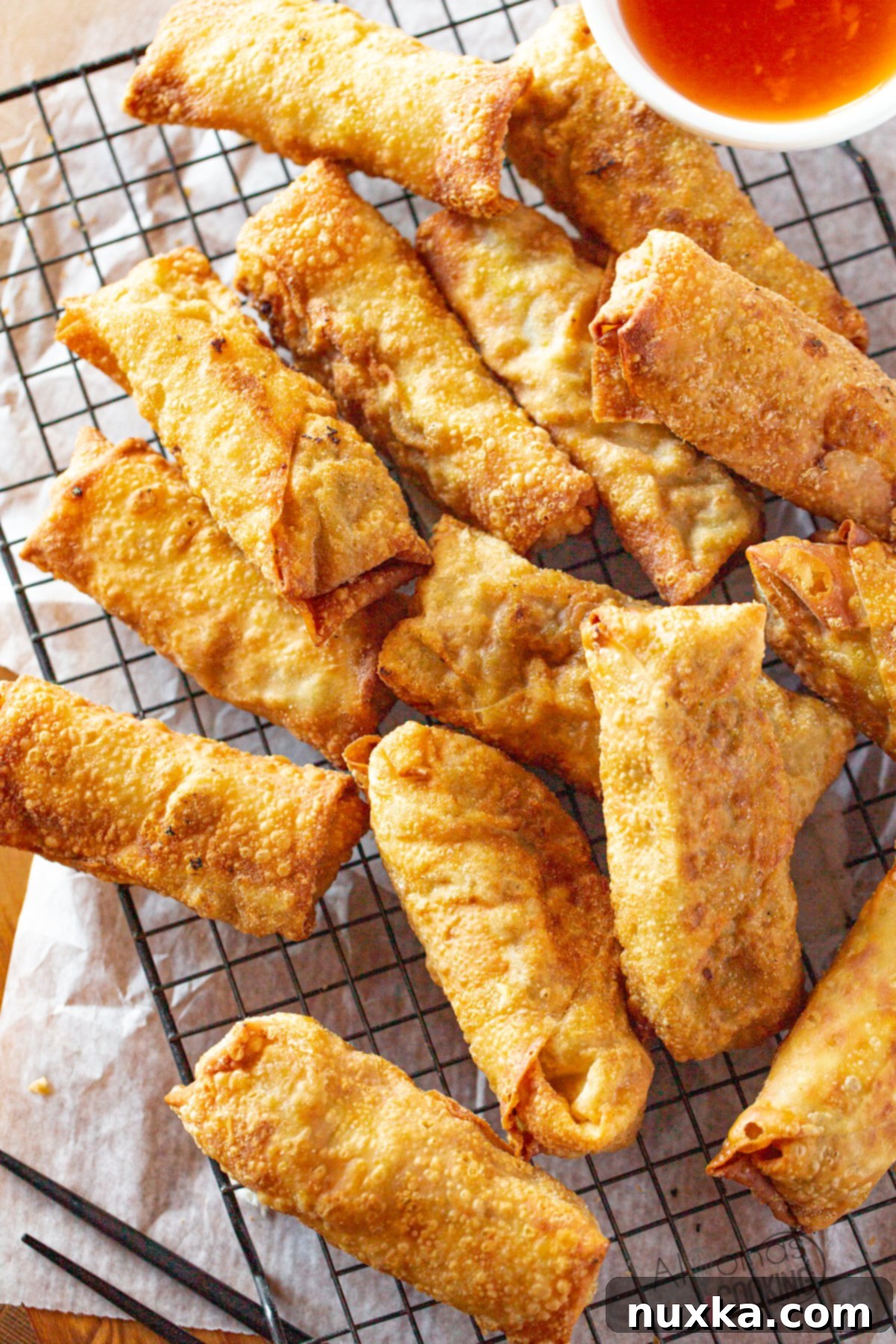 Authentic Chinese Egg Roll Recipe like Takeout - Golden brown, crispy egg rolls stacked on a plate.