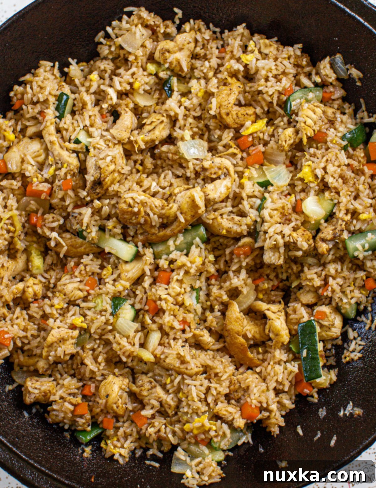 Sizzling Teriyaki Chicken and Fried Rice with homemade teriyaki sauce, mimicking a Hibachi grill dish