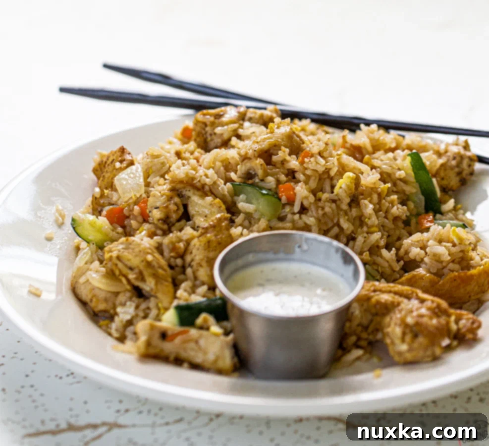 Delicious Teriyaki Chicken Fried Rice recipe cooked in a wok, full of fresh vegetables and chicken