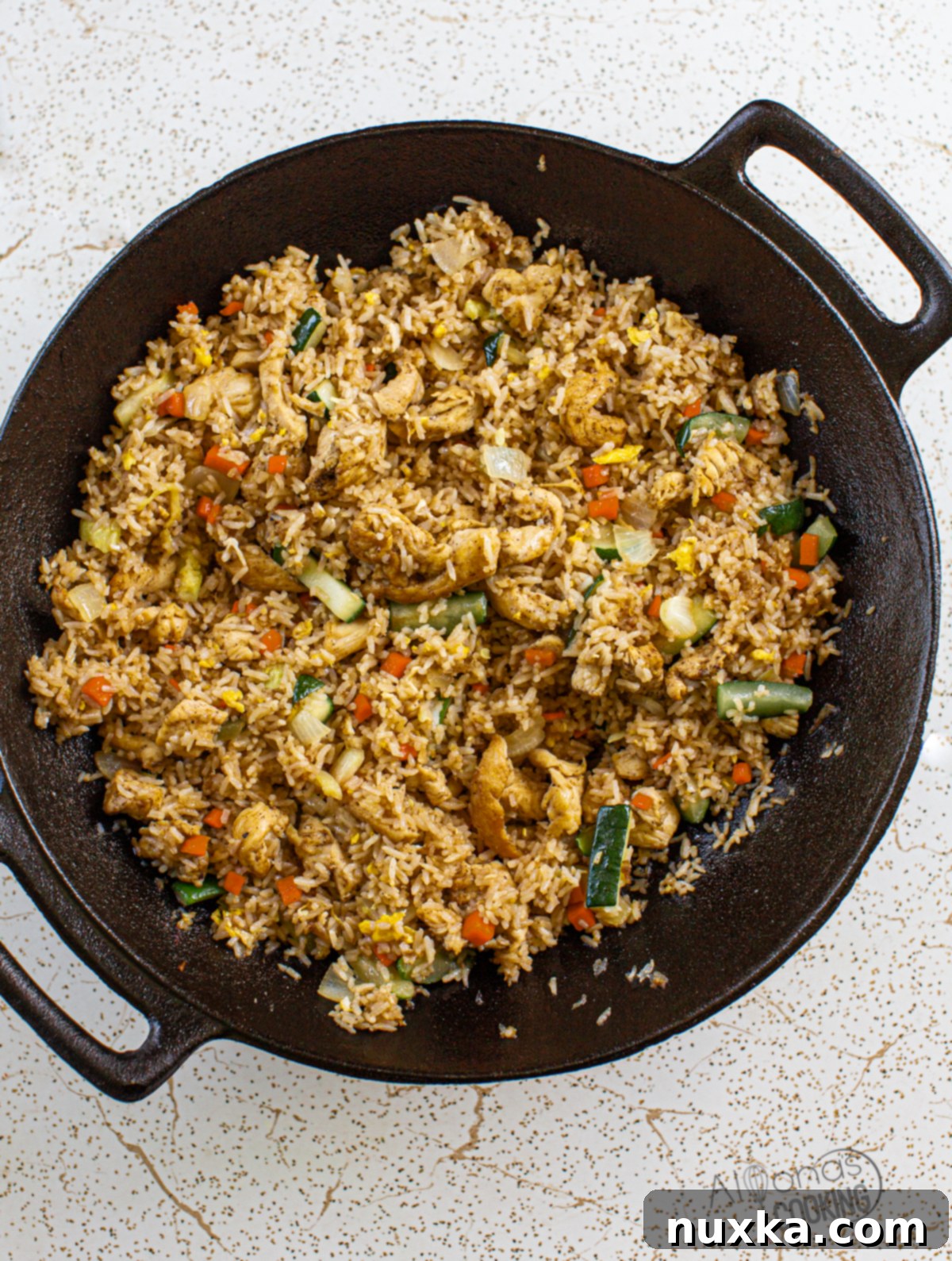 Close-up of Teriyaki Chicken Fried Rice being stir-fried in a Wok, showing the vibrant colors